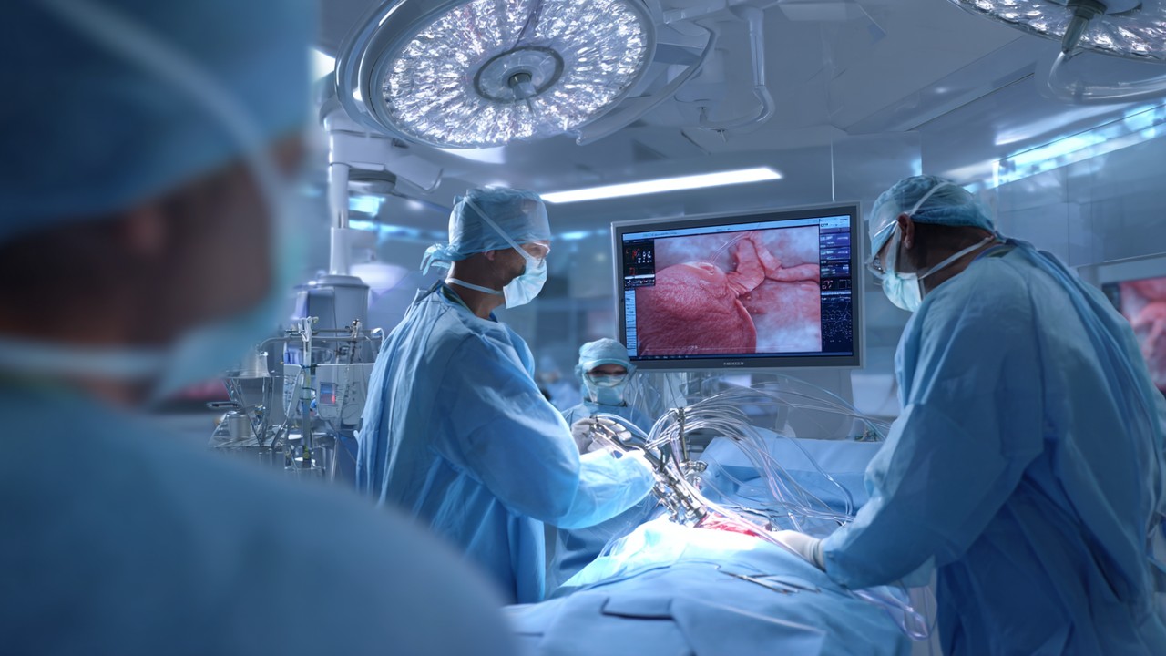 Realistic medical scene of a surgeon performing minimally invasive laparoscopic surgery with instruments and monitor in a modern operating room.