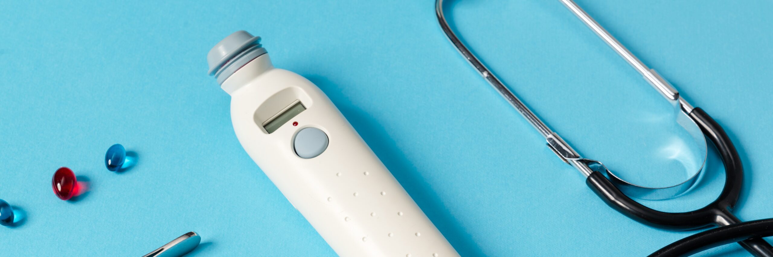 A close-up view of medical instruments lying on a blue background