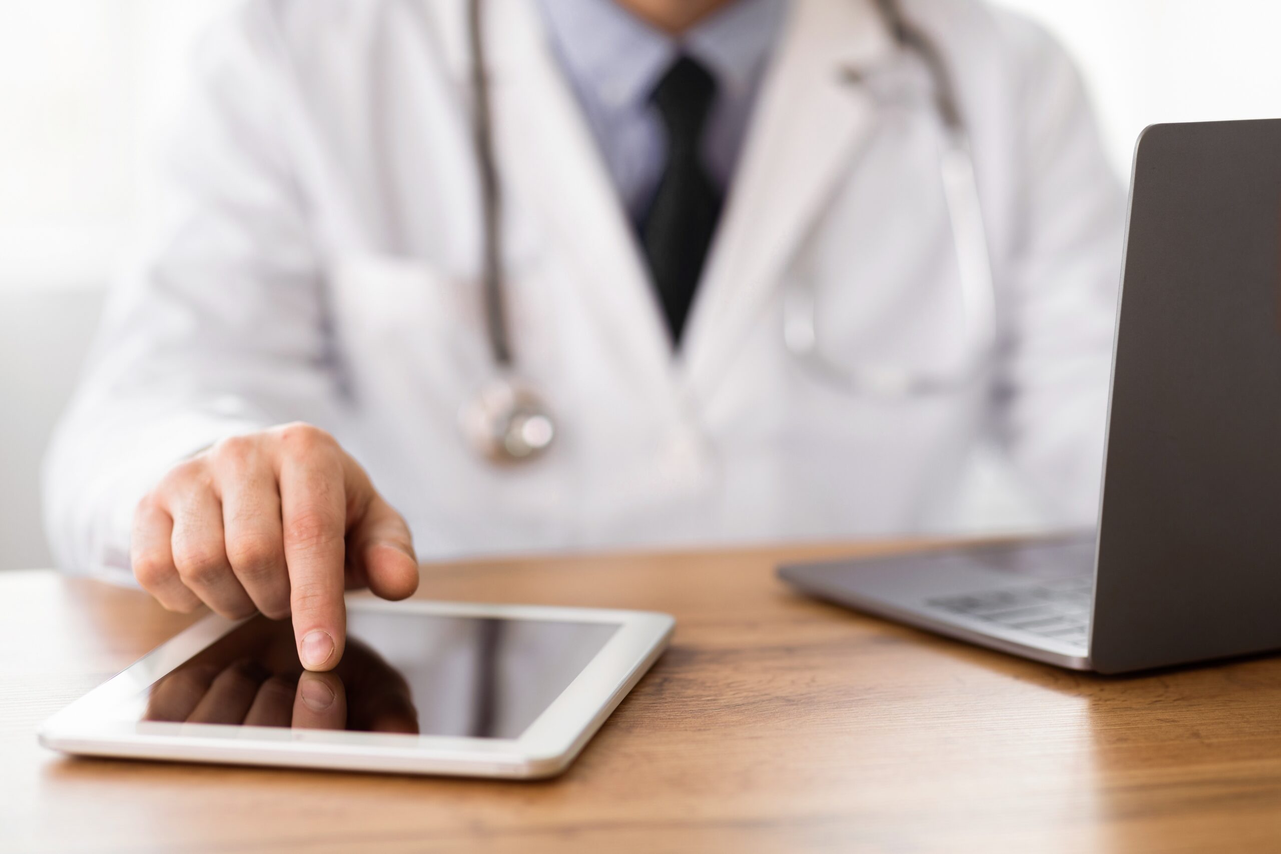 Close-up of medical practitioner using digital tablet