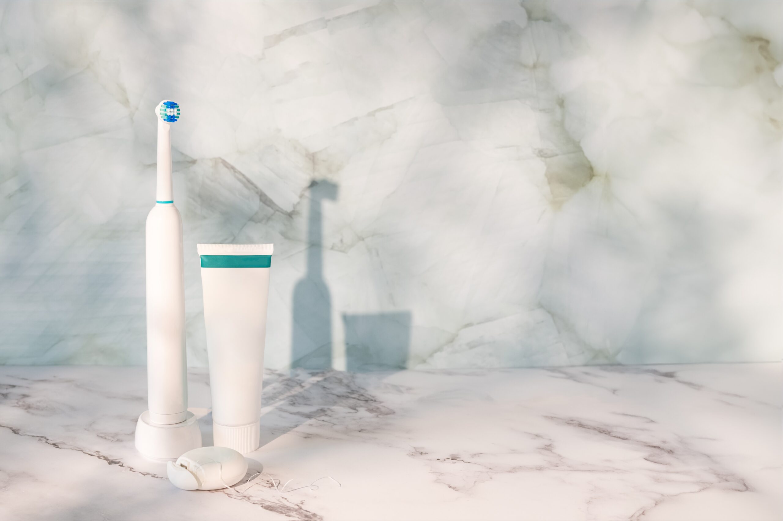 Dental hygiene and oral care, electric toothbrush paired with a tube of toothpaste.