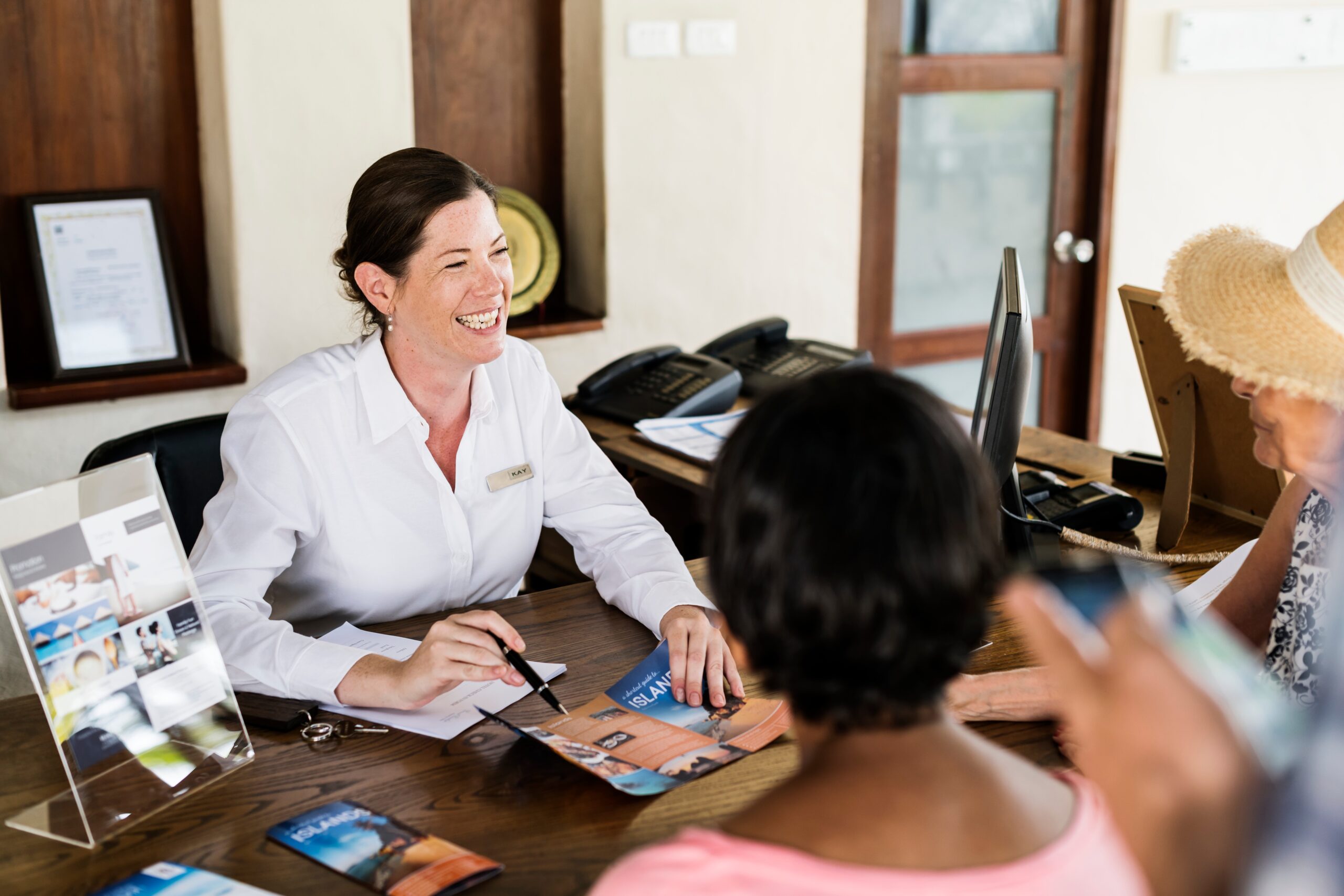 Resort receptionist speaking to a guest