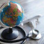 Selective focus image of globe, toy plane and stethoscope.