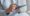 Woman use of mobile phone and sit on sofa at home